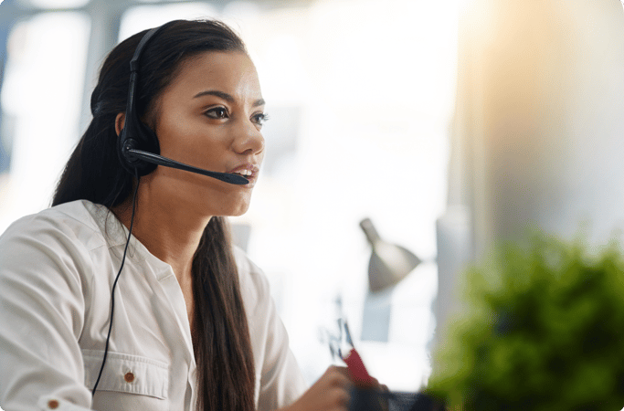 A picture of a customer service operator speaking to a client via a headset.